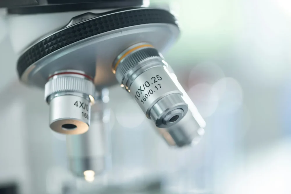 A zoomed in photo of a microscopes three lenses