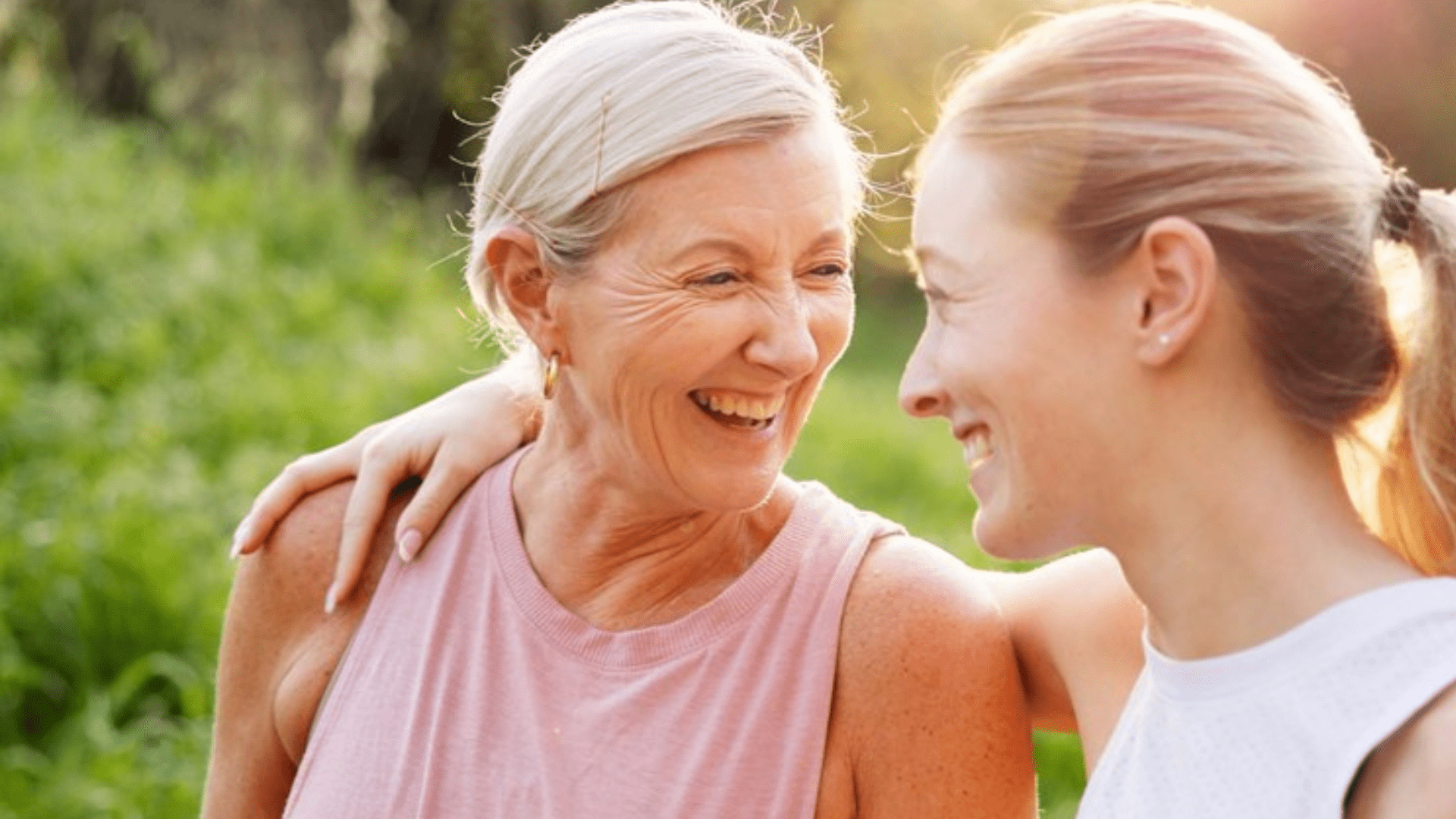 two woman looking at each other and smiling