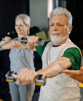 Man and woman exercising holding dumbell