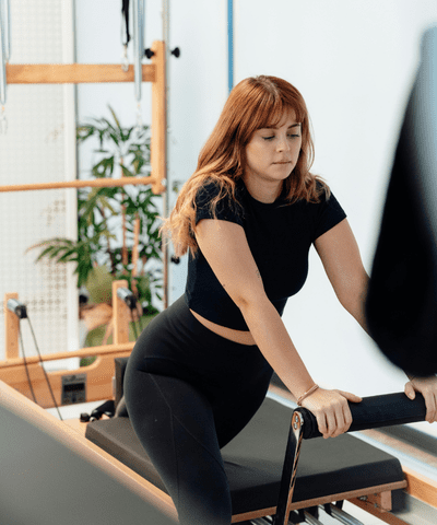 Woman on pilates former machine