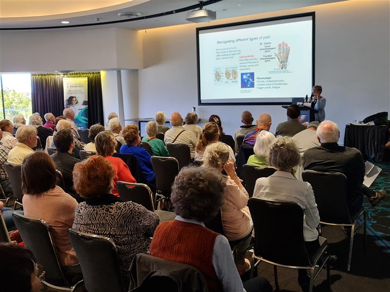 Audience listening to arthritis presentation at The Arthritis Movement's Community Wellness Day