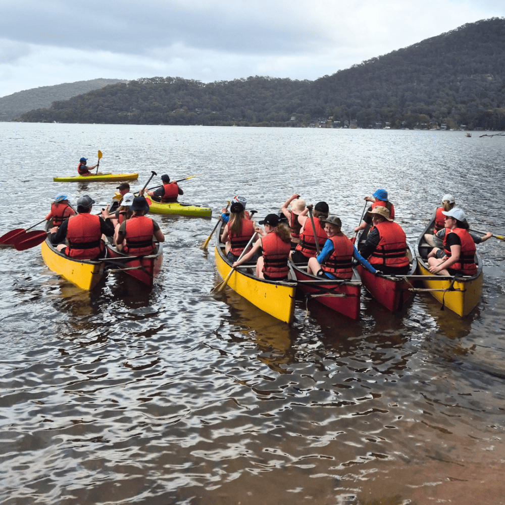 Kids Kayaking and paddling out on a lake